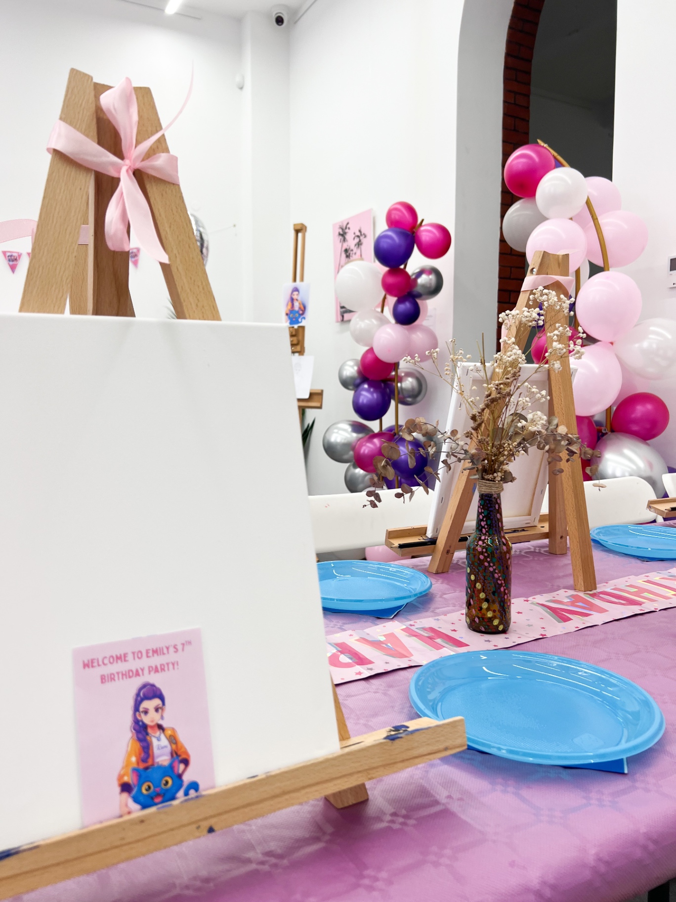 Close-up of a blank canvas easel with a personalised welcome card for the birthday child