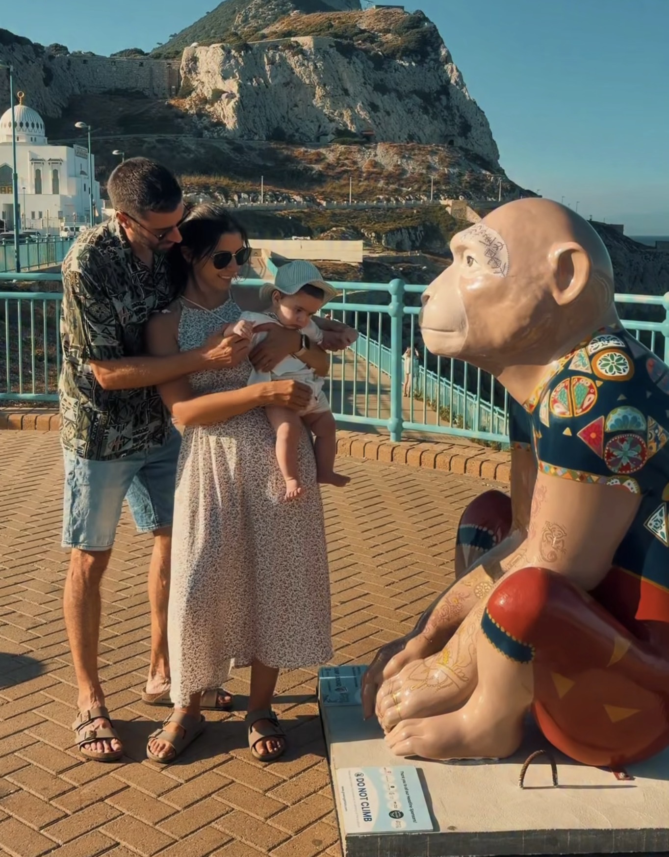 A family showing their baby one of the Barbary Macaque sculptures on the trail