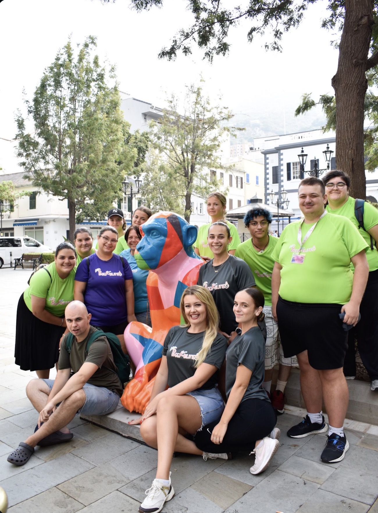 The Best Kept group posing with a geometric Barbary Macaque sculpture in town