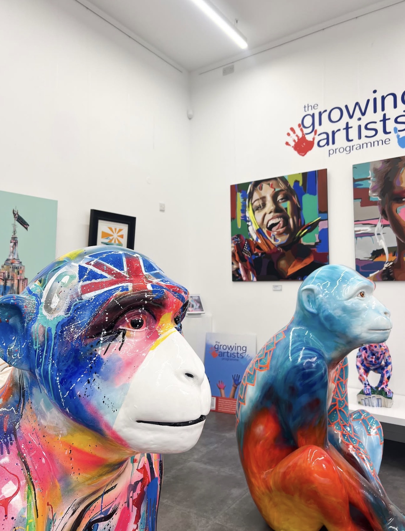 Two painted Barbary macaque sculptures on display at the Growing Artists Programme gallery