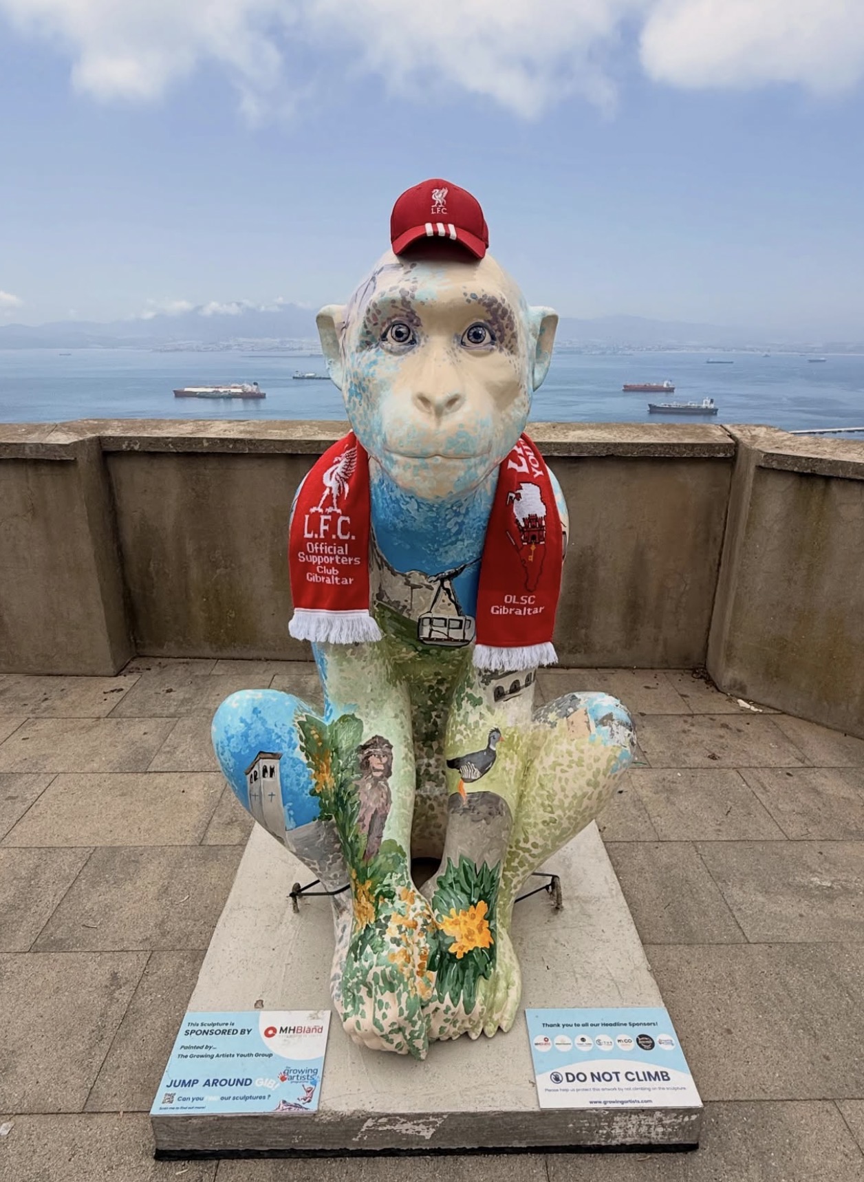 The Liverpool FC supporters' Barbary Macaque sculpture wearing a scarf and cap overlooking the bay
